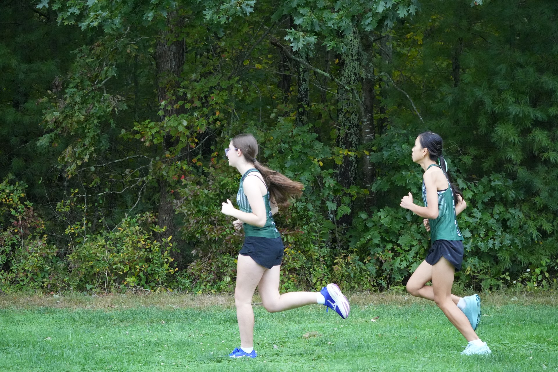Two Mansfield runners crossing the grass together.