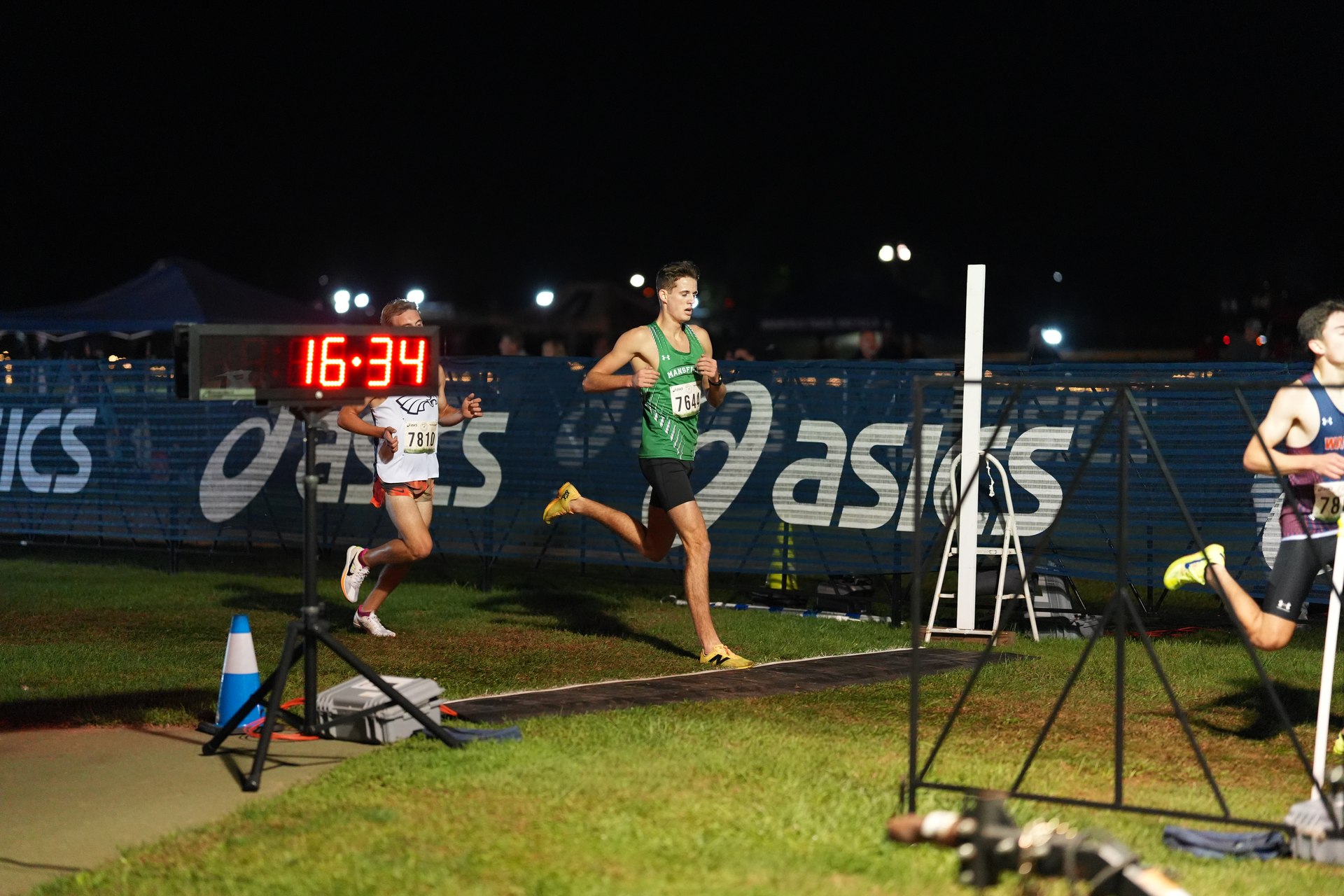 Walter Stock reaches the finish beneath the lights.