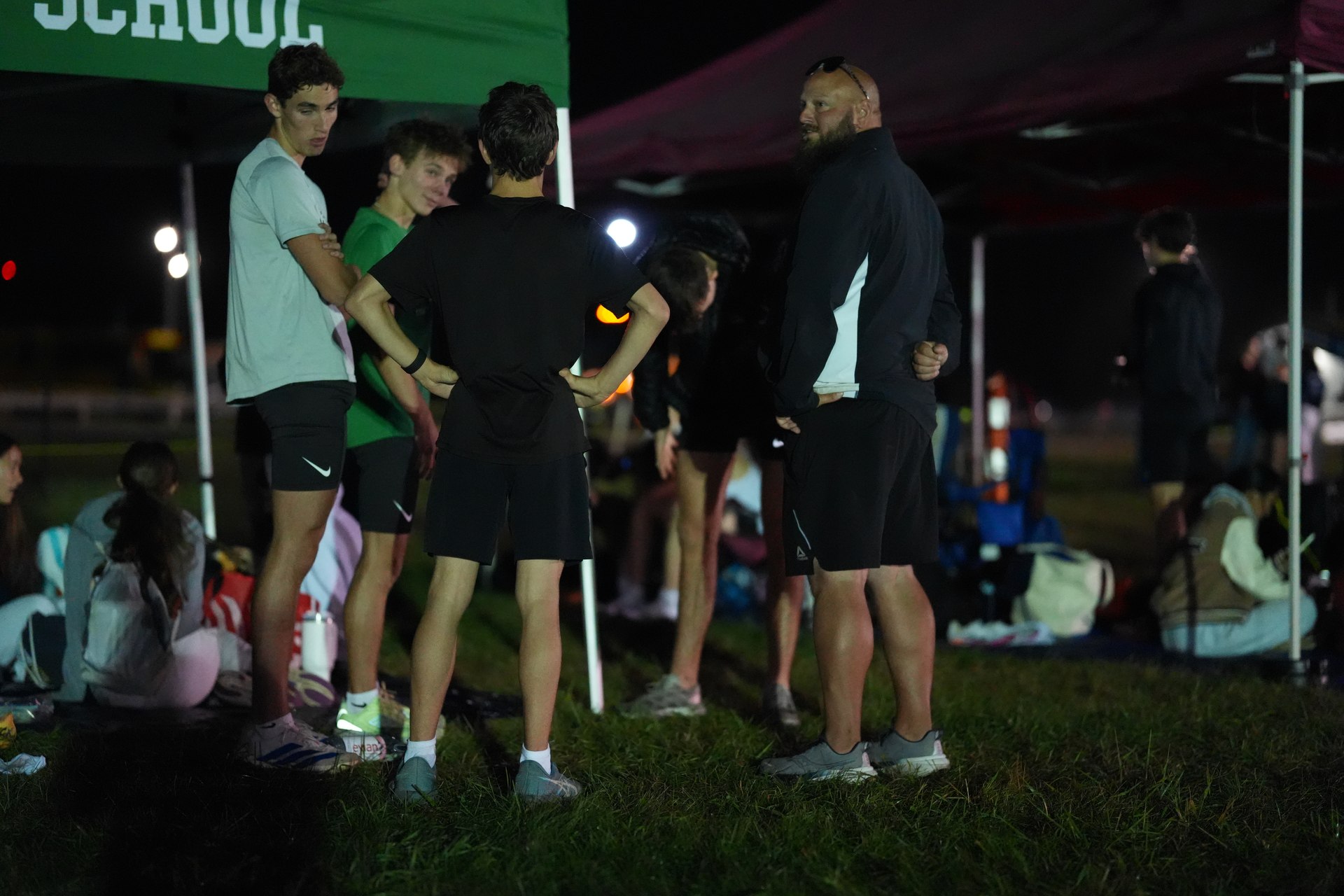 Jacob Hyre, Nikita Cherapukha, Walter Stock, Coach Butera and Barrett Reynolds gather beneath the Mansfield canopy.