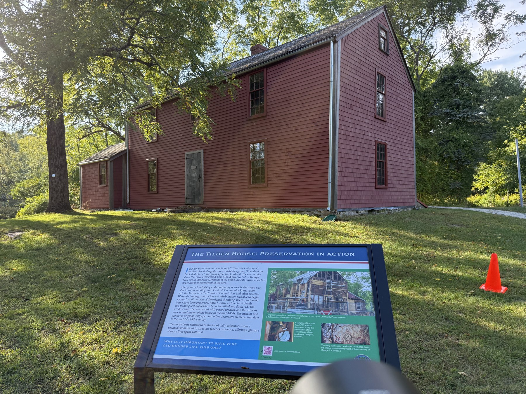 The red David and Abigail Tilden House beside yellow course tape.