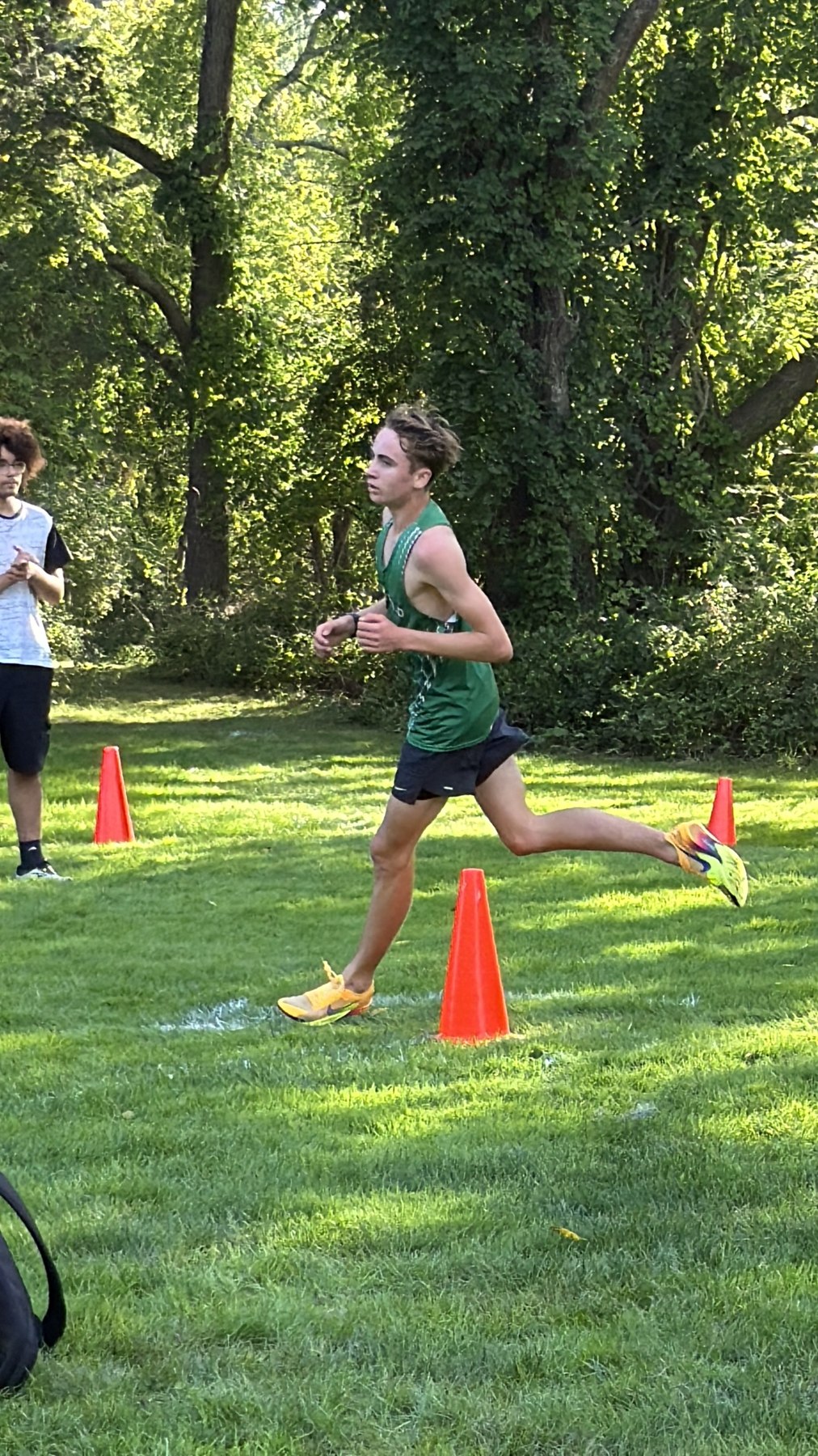 A Mansfield runner passing orange course cones.