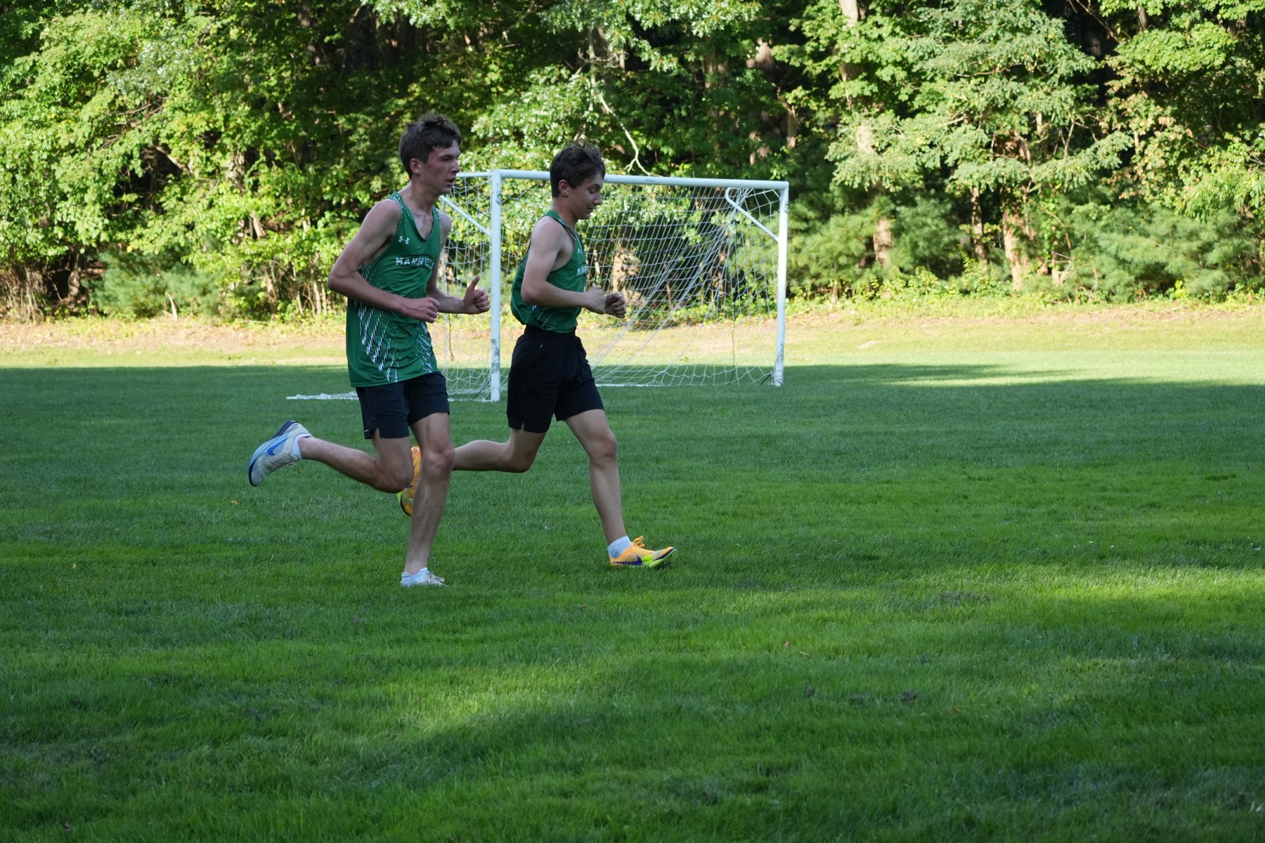 Two Mansfield runners side by side on the grass.