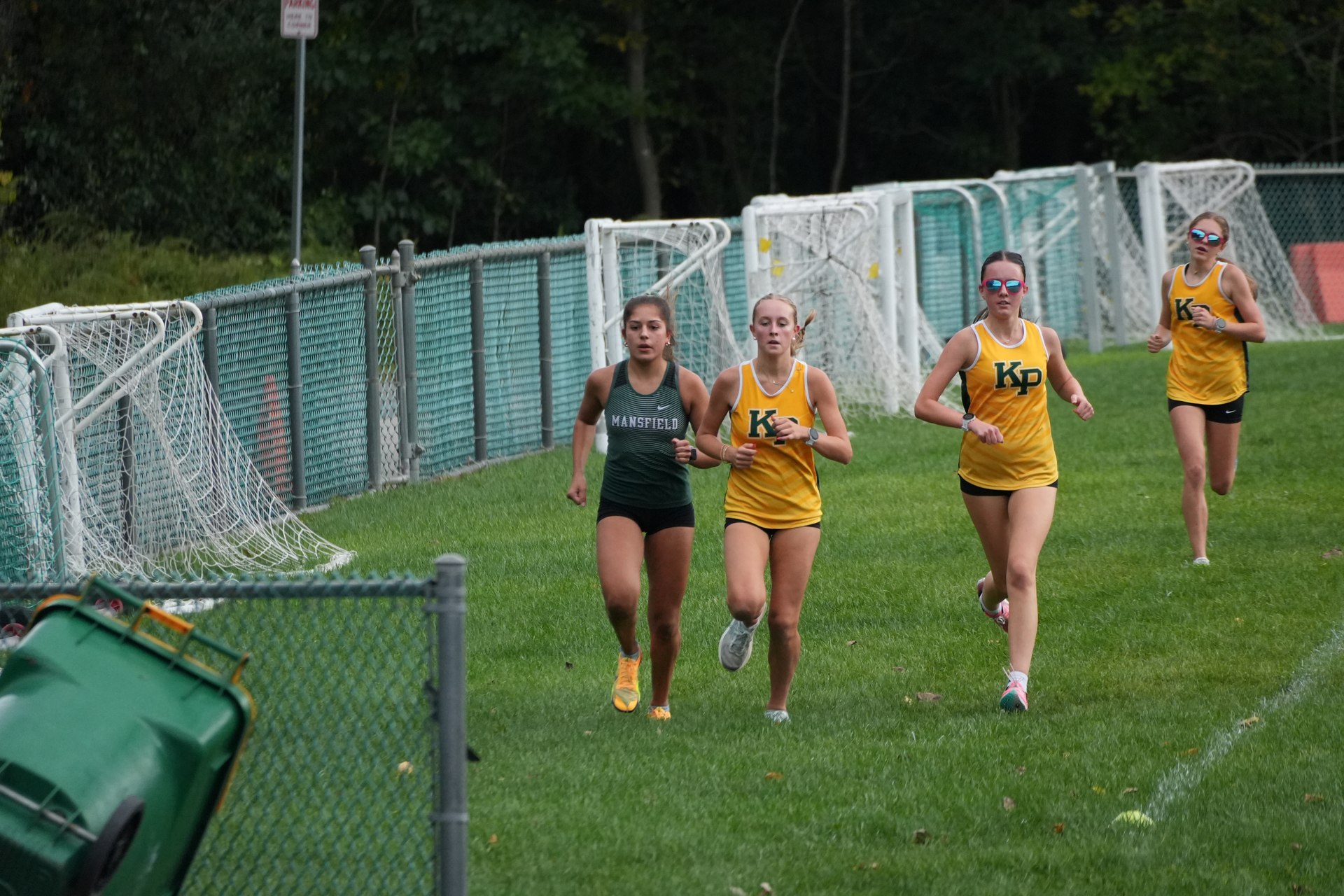 Mansfield and King Philip runners beside the soccer goals.