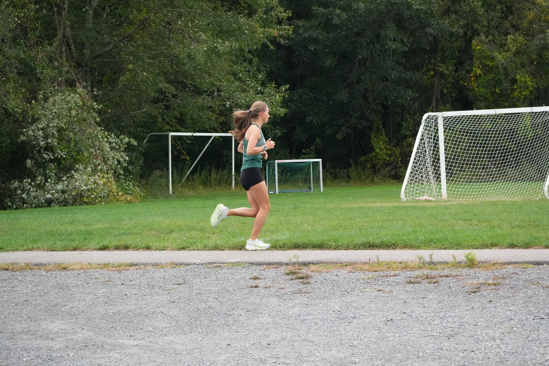A Mansfield runner passing the gravel and soccer goals.