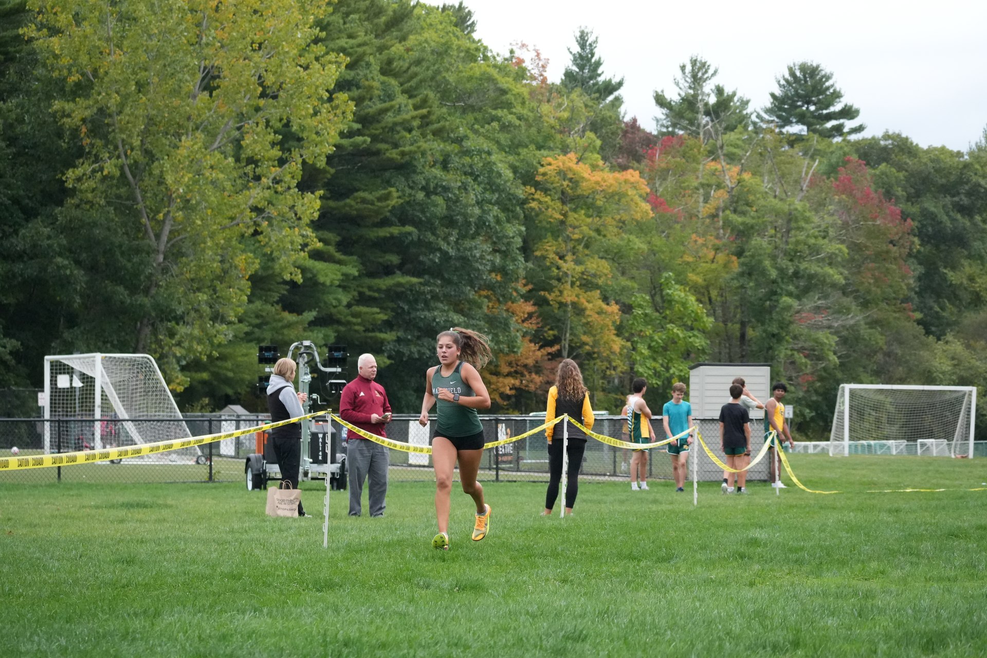 Back on open grass, with yellow tape marking the route.