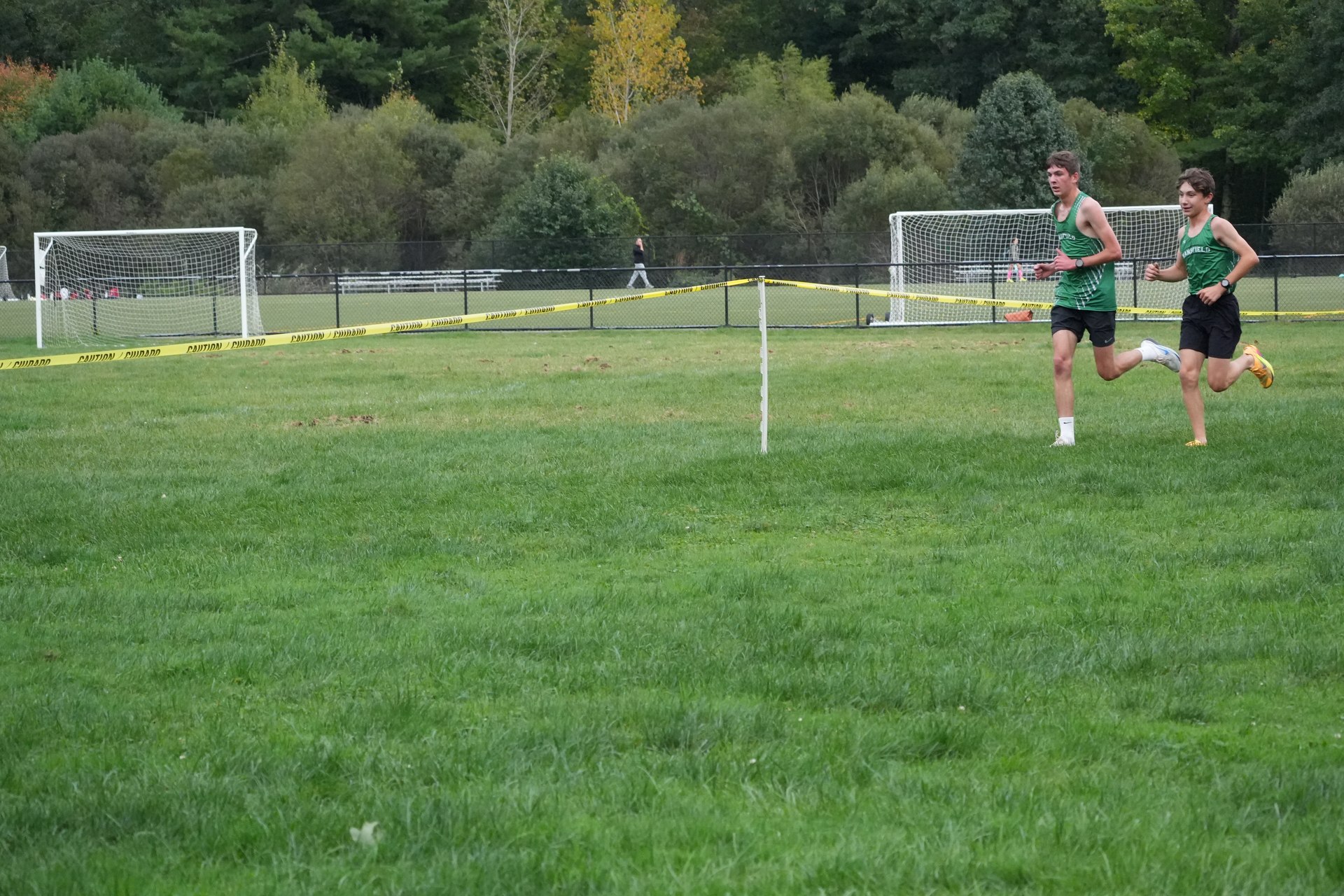 Two Mansfield runners crossing the field together.