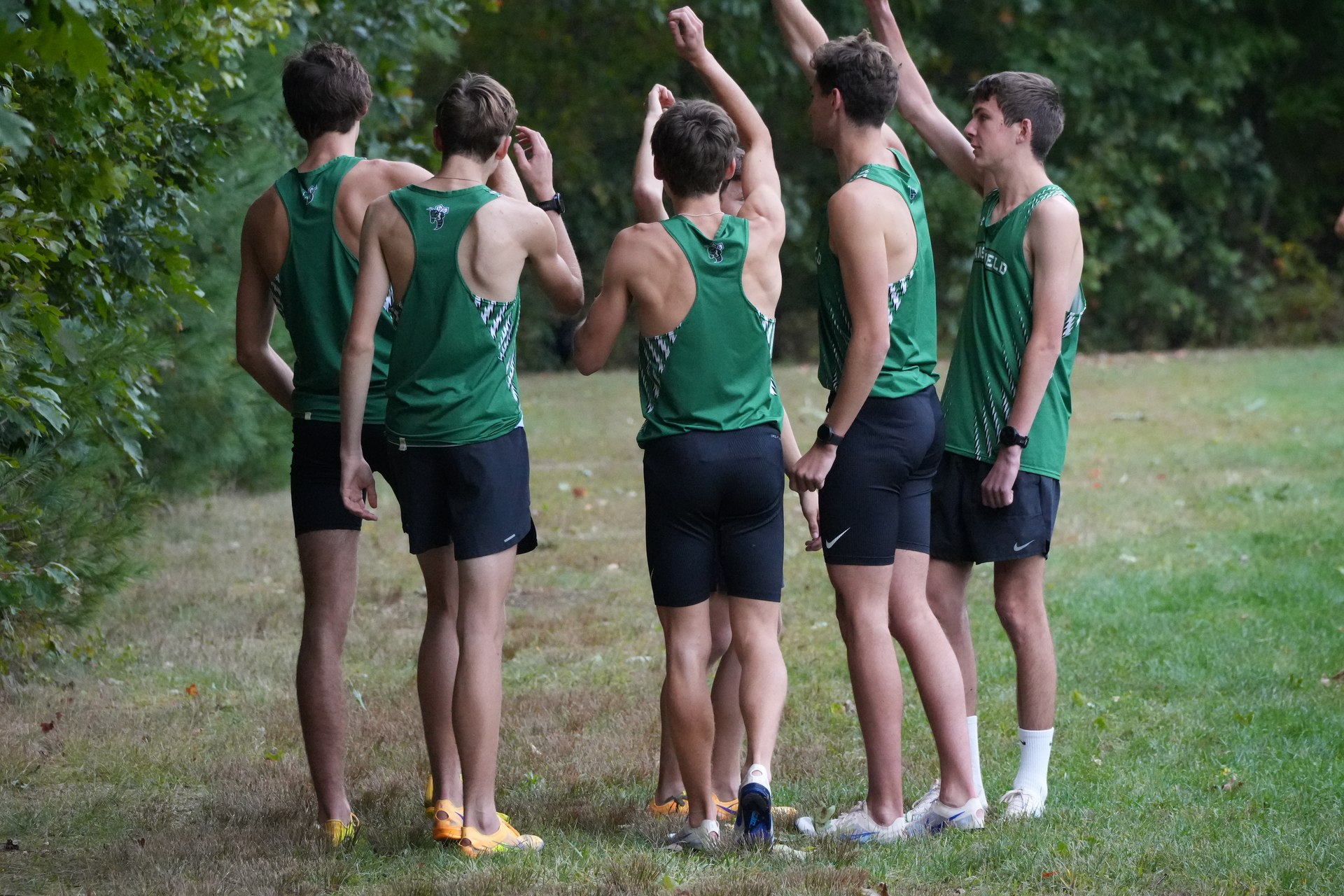 Hands raised as the team breaks from the huddle.