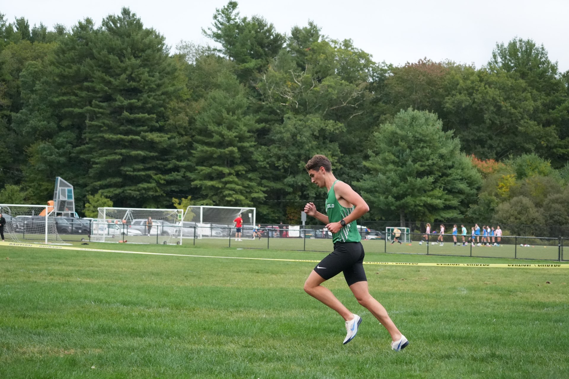 A Mansfield runner in stride on the grass.